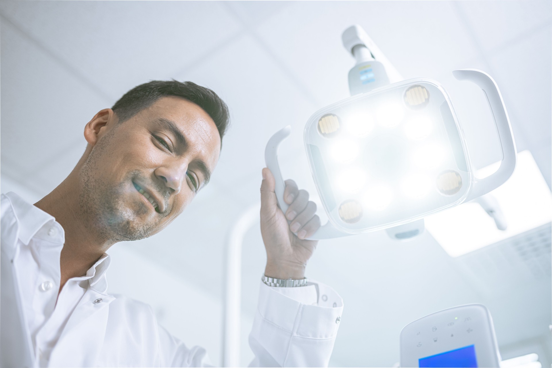 Portrait of confident a young dentist working in his consulting room